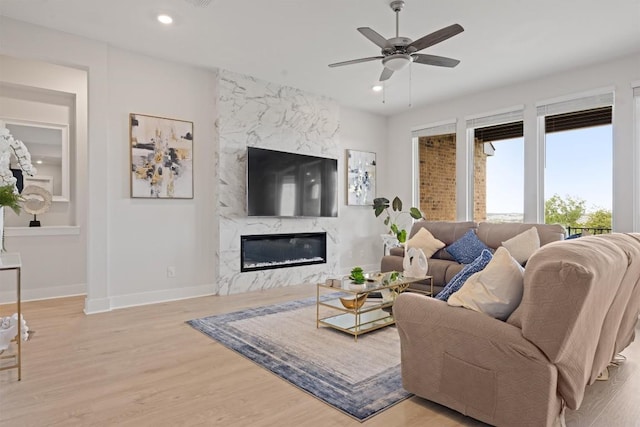 2233 Bellisa Vista Dr, Leander, TX 78641 - living area with a fireplace, light wood finished floors, a ceiling fan, and recessed lighting