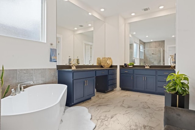 2233 Bellisa Vista Dr, Leander, TX 78641 - full bathroom with a stall shower, two vanities, a freestanding bath, healthy amount of natural light, and recessed lighting