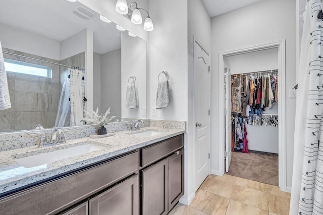717 Friars Tuck Dr, Temple, TX 76502 - full bathroom featuring double vanity, tiled shower, and a spacious closet