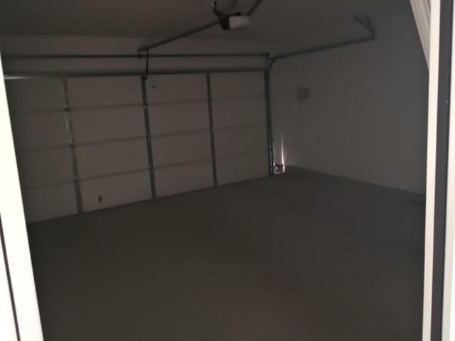 240 Line Of Fire Way, Jarrell, TX 76537 - garage featuring a garage door opener
