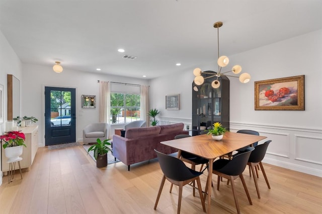 1105 Red Ranch Cir, Cedar Park, TX 78613 - dining space featuring light wood-style floors, wainscoting, recessed lighting, and a decorative wall