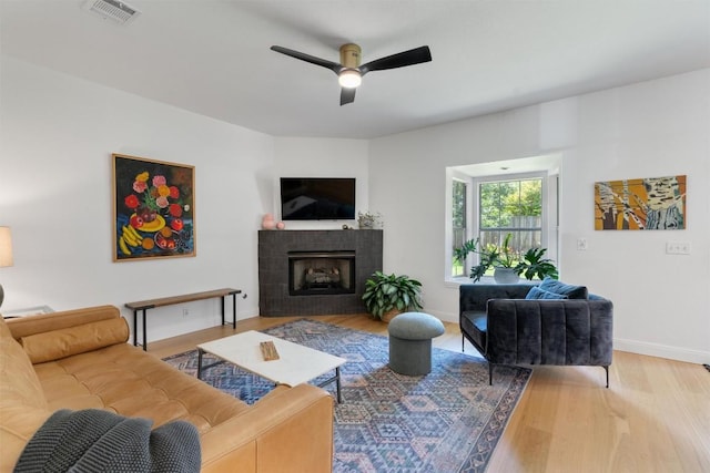 1105 Red Ranch Cir, Cedar Park, TX 78613 - living room with a ceiling fan, wood finished floors, and a tiled fireplace