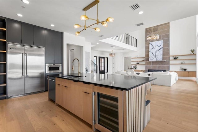 1000 Southlake Ranch Rd, Georgetown, TX 78628 - kitchen with appliances with stainless steel finishes, a chandelier, beverage cooler, open shelves, and dark countertops