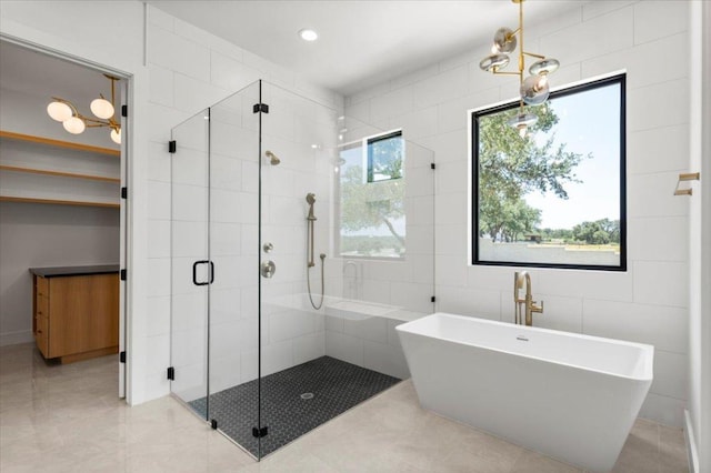 1000 Southlake Ranch Rd, Georgetown, TX 78628 - full bath featuring a stall shower, a soaking tub, tile walls, recessed lighting, and tile patterned flooring
