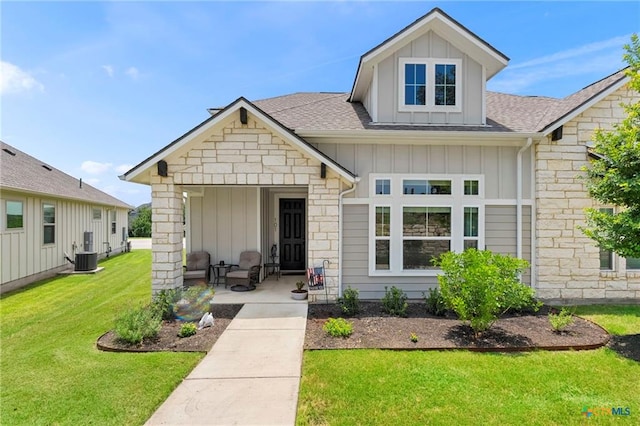 220 Bolivar Way Unit 101, San Marcos, TX 78666 - view of front of house featuring board and batten siding, stone siding, a front lawn, and a shingled roof