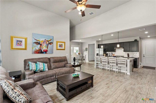 220 Bolivar Way Unit 101, San Marcos, TX 78666 - living area with a ceiling fan, a towering ceiling, light wood-style flooring, and recessed lighting