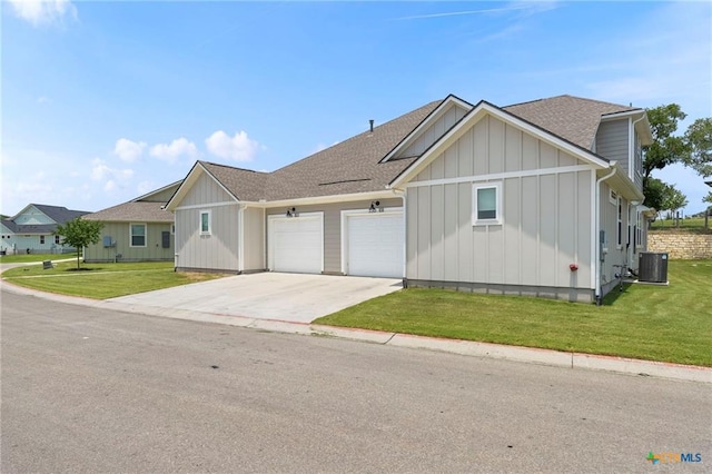 220 Bolivar Way Unit 101, San Marcos, TX 78666 - view of front of house with board and batten siding, a garage, concrete driveway, and a front lawn