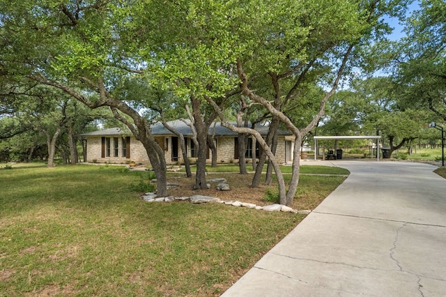 216 Country Rd, Georgetown, TX 78628 - view of front of house featuring driveway, a front lawn, and a detached carport