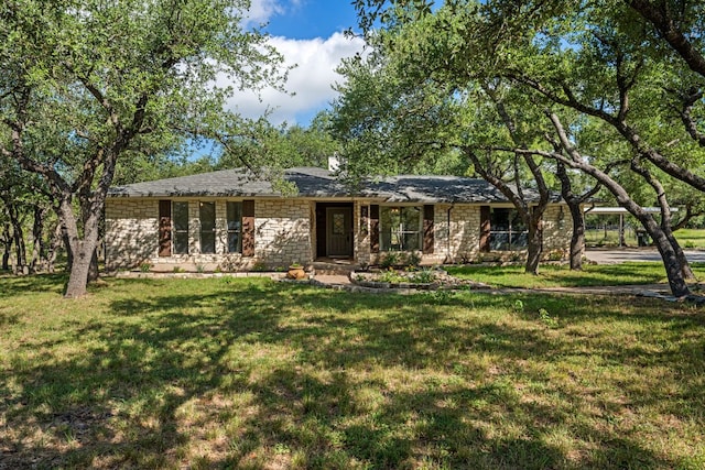 216 Country Rd, Georgetown, TX 78628 - ranch-style home with stone siding, a front yard, and a carport