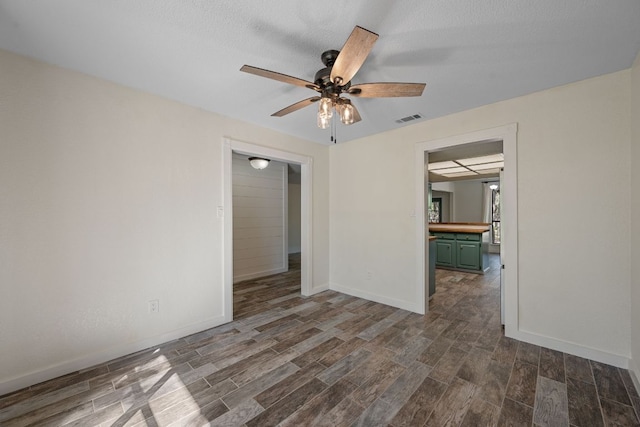 216 Country Rd, Georgetown, TX 78628 - unfurnished room with dark wood-style floors and a ceiling fan