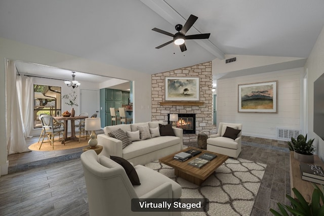 216 Country Rd, Georgetown, TX 78628 - living area featuring wood finished floors, a stone fireplace, ceiling fan, and a chandelier