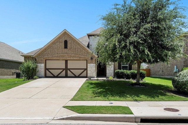 1008 Tabernash Dr, Leander, TX 78641 - view of front facade with stone siding, a front lawn, an attached garage, and concrete driveway