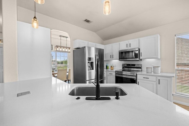 203 Ponderosa Dr, Harker Heights, TX 76548 - kitchen with appliances with stainless steel finishes, light countertops, pendant lighting, white cabinetry, and lofted ceiling