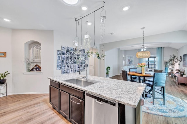1904 T H Johnson Dr, Taylor, TX 76574 - kitchen with dishwasher, light wood-style floors, dark brown cabinetry, decorative light fixtures, and recessed lighting