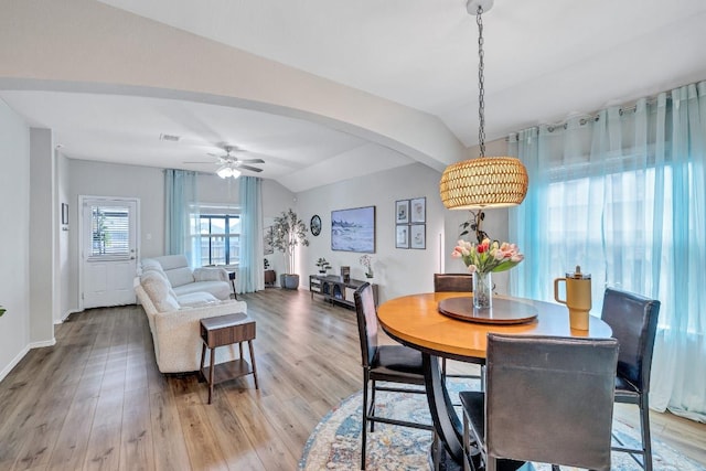1904 T H Johnson Dr, Taylor, TX 76574 - dining area with lofted ceiling, light wood-type flooring, ceiling fan, and arched walkways