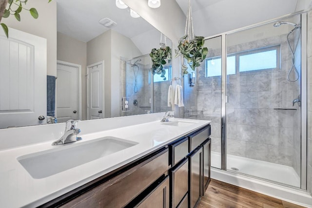 1904 T H Johnson Dr, Taylor, TX 76574 - full bathroom featuring wood finished floors, a stall shower, double vanity, and lofted ceiling