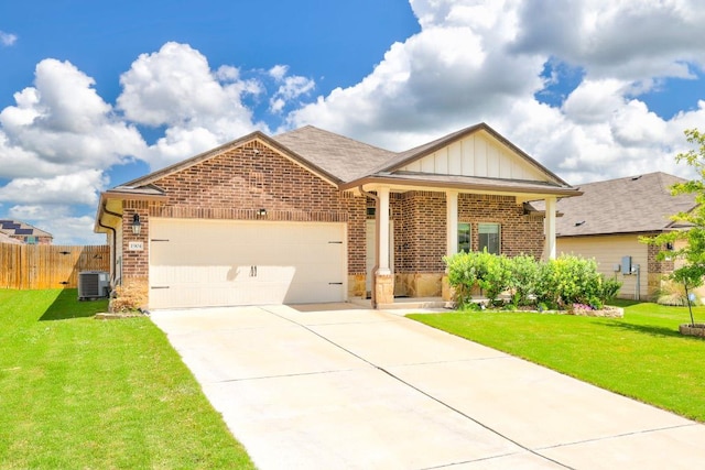 1904 T H Johnson Dr, Taylor, TX 76574 - view of front of property featuring brick siding, a garage, concrete driveway, and board and batten siding
