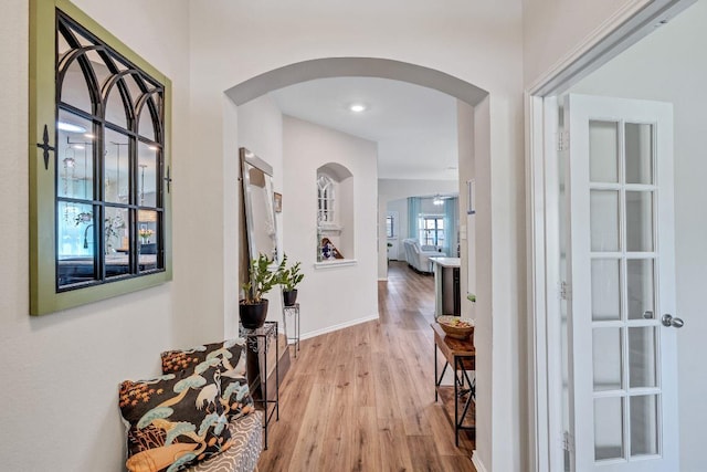1904 T H Johnson Dr, Taylor, TX 76574 - hallway featuring arched walkways and wood finished floors
