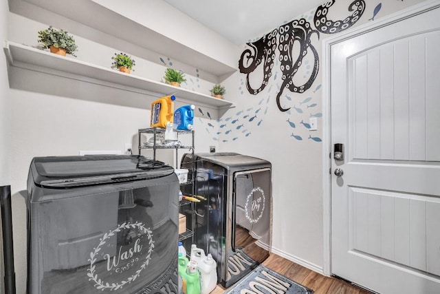 1904 T H Johnson Dr, Taylor, TX 76574 - laundry area with washing machine and clothes dryer and wood finished floors