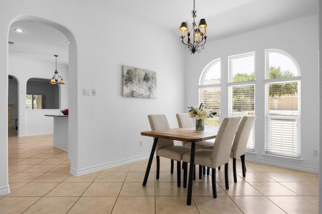 9601 Billingham Trl, Austin, TX 78717 - dining room with arched walkways, light tile patterned floors, and a chandelier