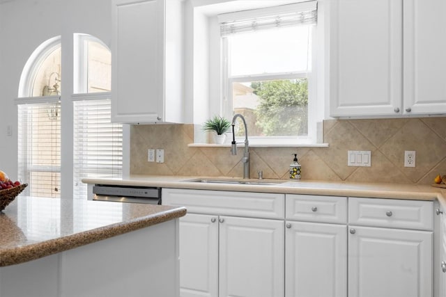 9601 Billingham Trl, Austin, TX 78717 - kitchen with white cabinets, backsplash, and stainless steel dishwasher