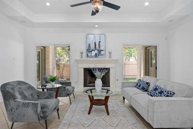 9601 Billingham Trl, Austin, TX 78717 - living room featuring a tray ceiling, healthy amount of natural light, a fireplace, ceiling fan, and crown molding