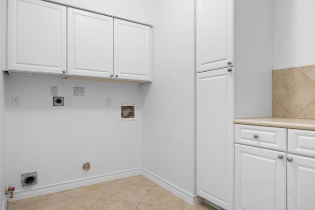 9601 Billingham Trl, Austin, TX 78717 - laundry room with hookup for a gas dryer, hookup for an electric dryer, washer hookup, cabinet space, and light tile patterned flooring