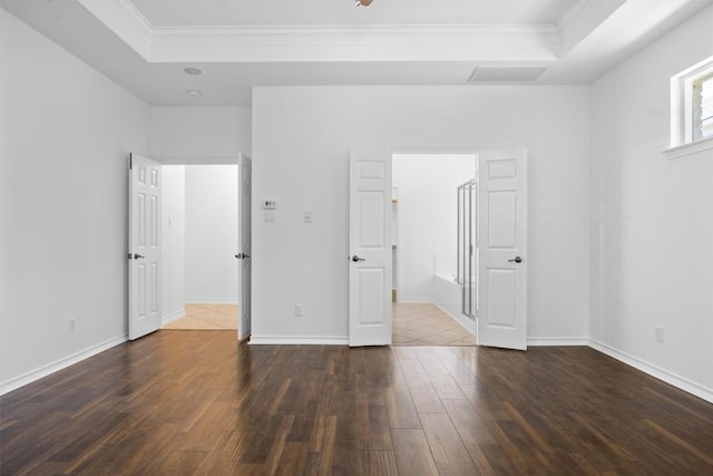 9601 Billingham Trl, Austin, TX 78717 - unfurnished bedroom with a raised ceiling, crown molding, and dark wood-type flooring