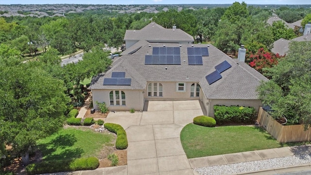 9601 Billingham Trl, Austin, TX 78717 - view of front of property featuring roof with shingles, roof mounted solar panels, a chimney, and stucco siding