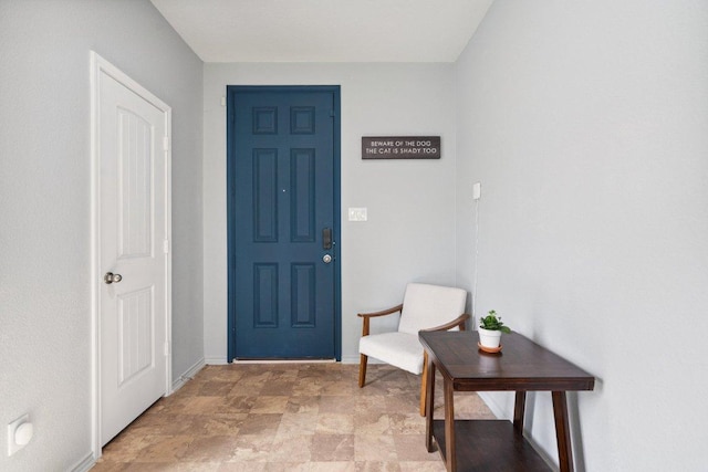 13821 Benjamin Harrison St, Manor, TX 78653 - foyer with baseboards and stone finish flooring