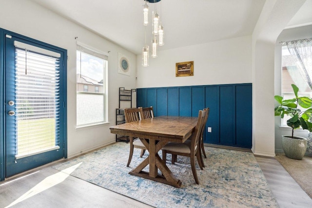 13821 Benjamin Harrison St, Manor, TX 78653 - dining room featuring healthy amount of natural light, wood finished floors, and wainscoting