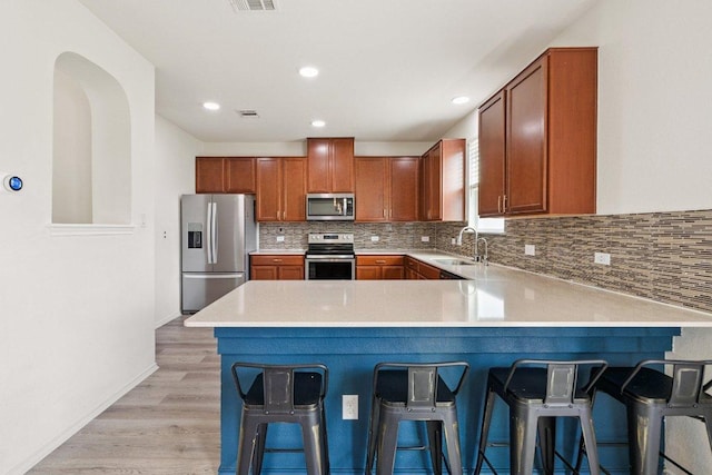 13821 Benjamin Harrison St, Manor, TX 78653 - kitchen featuring stainless steel appliances, tasteful backsplash, light countertops, a peninsula, and recessed lighting