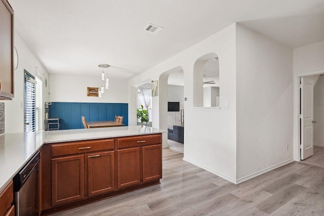 13821 Benjamin Harrison St, Manor, TX 78653 - kitchen with a peninsula, light wood-style flooring, light countertops, and dishwasher