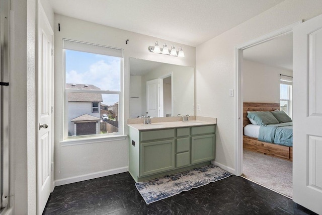 13821 Benjamin Harrison St, Manor, TX 78653 - ensuite bathroom featuring double vanity and baseboards