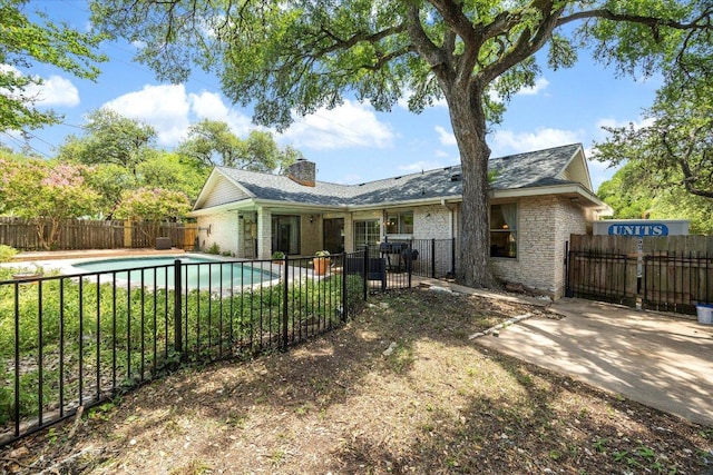 9902 Marseilles Dr, Austin, TX 78750 - rear view of house featuring a chimney, a fenced backyard, brick siding, and a patio area