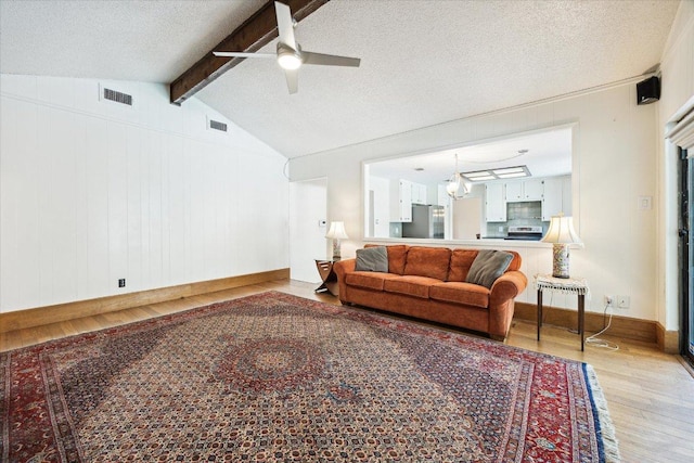 9902 Marseilles Dr, Austin, TX 78750 - living room with wood finished floors, a ceiling fan, and a textured ceiling