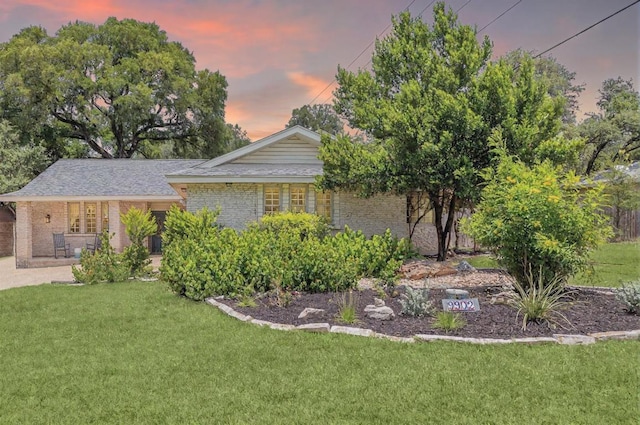 9902 Marseilles Dr, Austin, TX 78750 - view of front of house featuring brick siding, a front lawn, and covered porch