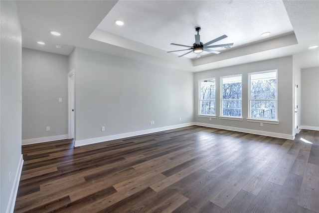 1720 Cannon St, Gonzales, TX 78629 - unfurnished room with a raised ceiling, ceiling fan, dark wood-type flooring, and recessed lighting