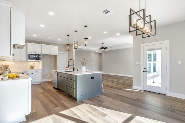 1720 Cannon St, Gonzales, TX 78629 - kitchen featuring stainless steel appliances, light wood-style floors, recessed lighting, a ceiling fan, and white cabinetry