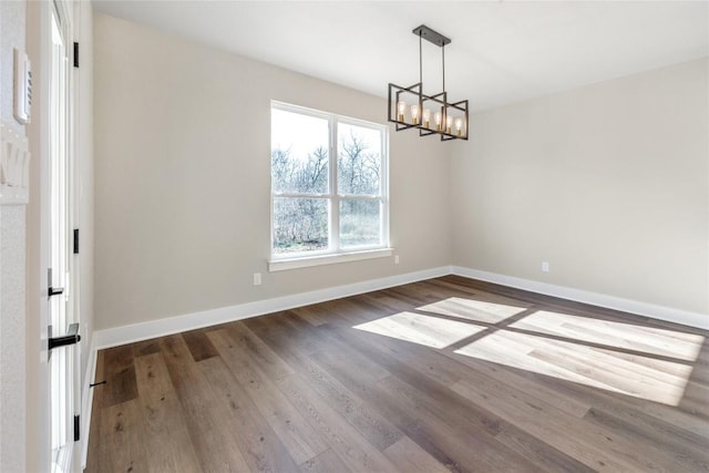 1720 Cannon St, Gonzales, TX 78629 - unfurnished room with a chandelier and wood finished floors