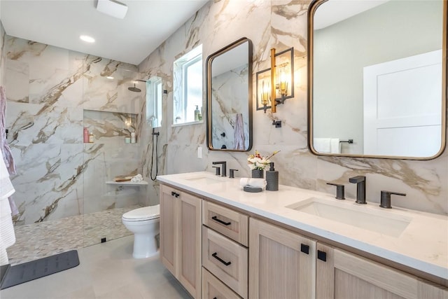1720 Cannon St, Gonzales, TX 78629 - full bathroom featuring double vanity, a marble finish shower, and tile walls