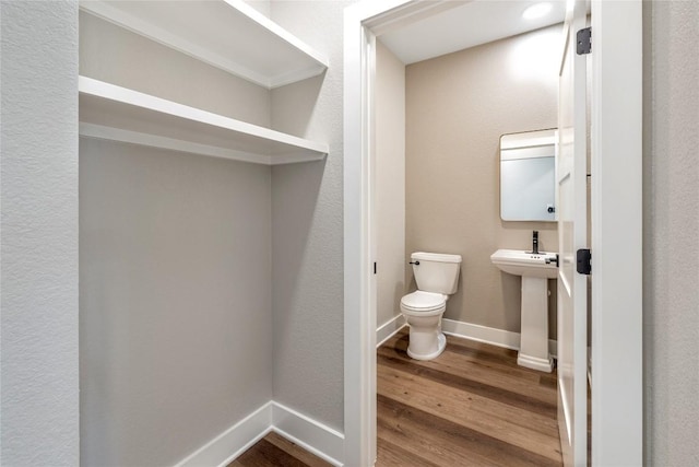 1720 Cannon St, Gonzales, TX 78629 - bathroom with wood finished floors and toilet