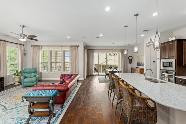 249 Hopping Peach St, San Marcos, TX 78666 - living area featuring dark wood-type flooring, healthy amount of natural light, recessed lighting, a chandelier, and ceiling fan