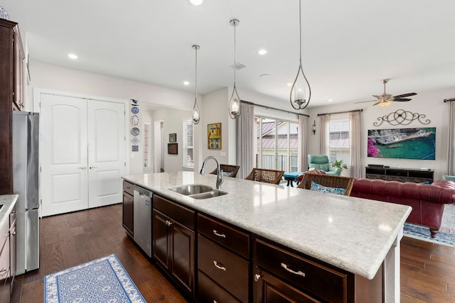 249 Hopping Peach St, San Marcos, TX 78666 - kitchen with appliances with stainless steel finishes, a center island with sink, dark wood-style floors, open floor plan, and ceiling fan
