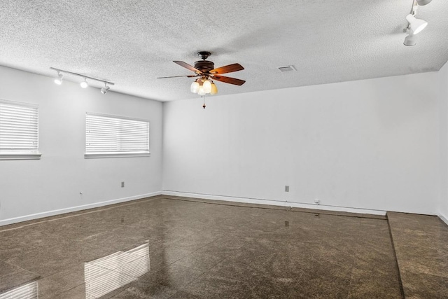 6308 Shadow Bnd, Austin, TX 78745 - unfurnished room featuring track lighting, a ceiling fan, a textured ceiling, and granite floors