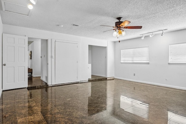 6308 Shadow Bnd, Austin, TX 78745 - unfurnished room featuring granite floors, ceiling fan, and a textured ceiling