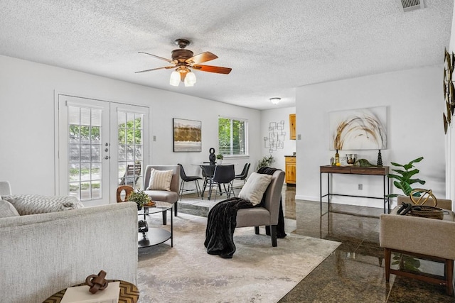 6308 Shadow Bnd, Austin, TX 78745 - living area featuring french doors, ceiling fan, a textured ceiling, and granite tiled floors