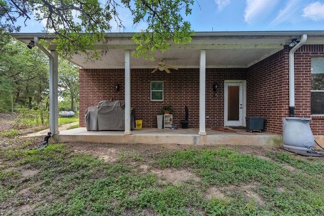 230 Hoffman Rd, Bastrop, TX 78602 - rear view of house featuring ceiling fan, a patio area, and brick siding