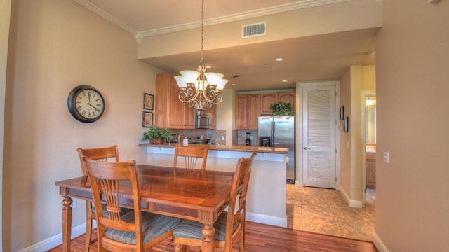 101 W Bank Unit 51, Horseshoe Bay, TX 78657 - dining space with a chandelier, ornamental molding, and recessed lighting