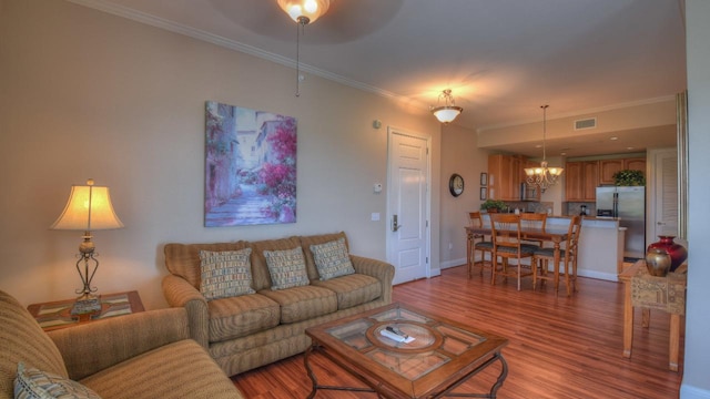 101 W Bank Unit 51, Horseshoe Bay, TX 78657 - living room featuring a chandelier, wood finished floors, crown molding, and ceiling fan